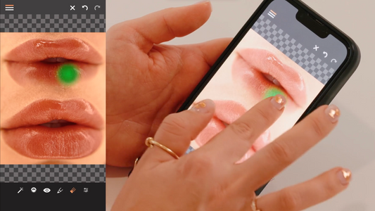 A hand with manicured nails interacts with a smartphone displaying edited lips.