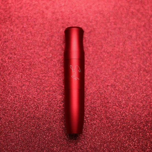 Red tube-shaped device with a matte finish, positioned on a sparkling red background.