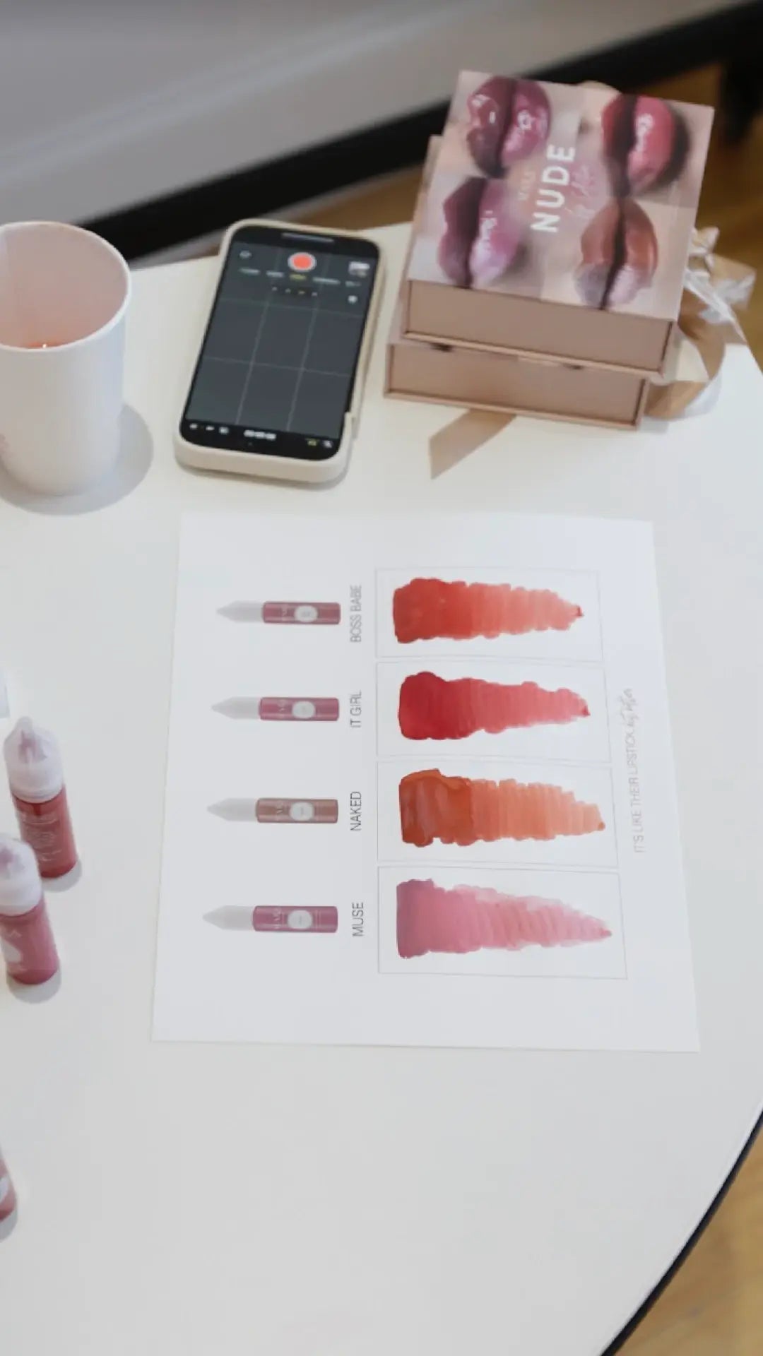 Consultation table with a phone, printed swatch card and MARA PRO pigment bottles